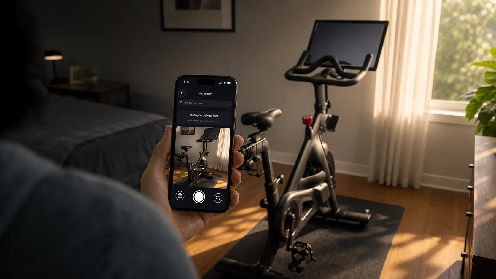 A phone scanning a stationary bike in a home exercise room